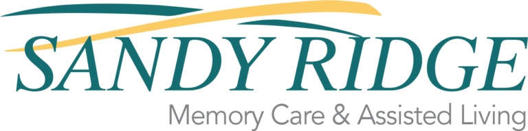 Sandy Ridge logo featuring the name in teal with a yellow swoosh. Represents memory care and assisted living services.
